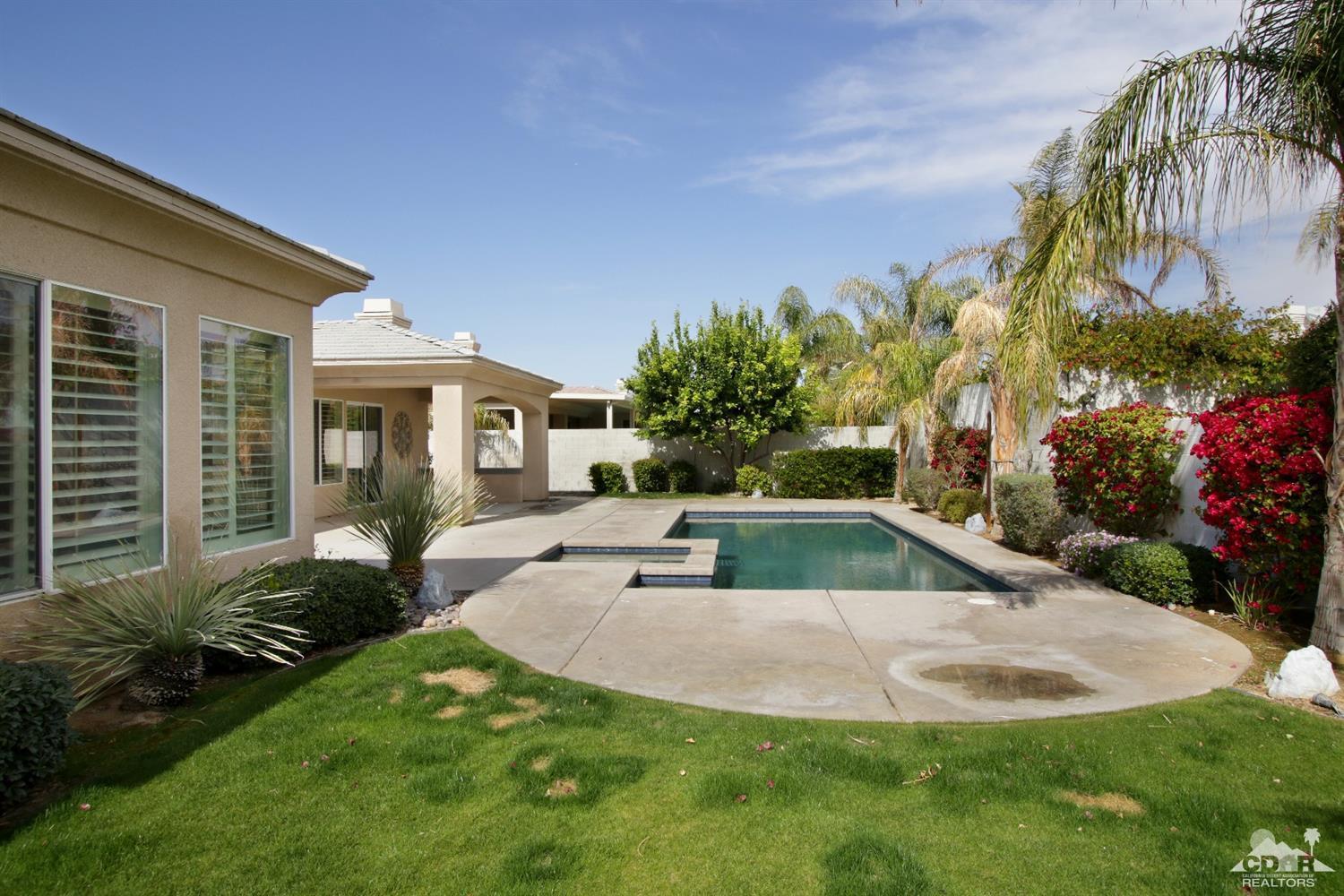 4 Orleans Road Rancho Mirage, CA 92270 - Photo 30 of 35 a view of backyard with swimming pool and outdoor seating