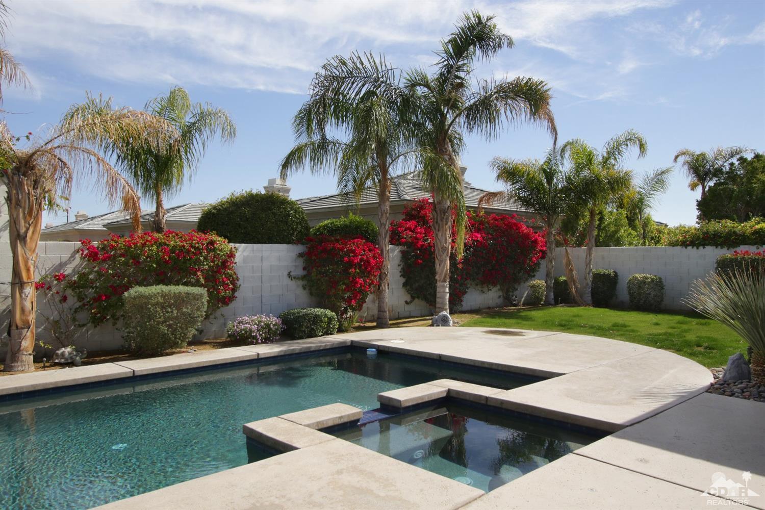 4 Orleans Road Rancho Mirage, CA 92270 - Photo 5 of 35 a view of a backyard with a garden and palm trees