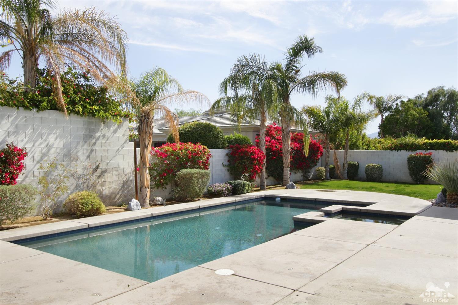 4 Orleans Road Rancho Mirage, CA 92270 - Photo 6 of 35 a house with palm tree in front of it