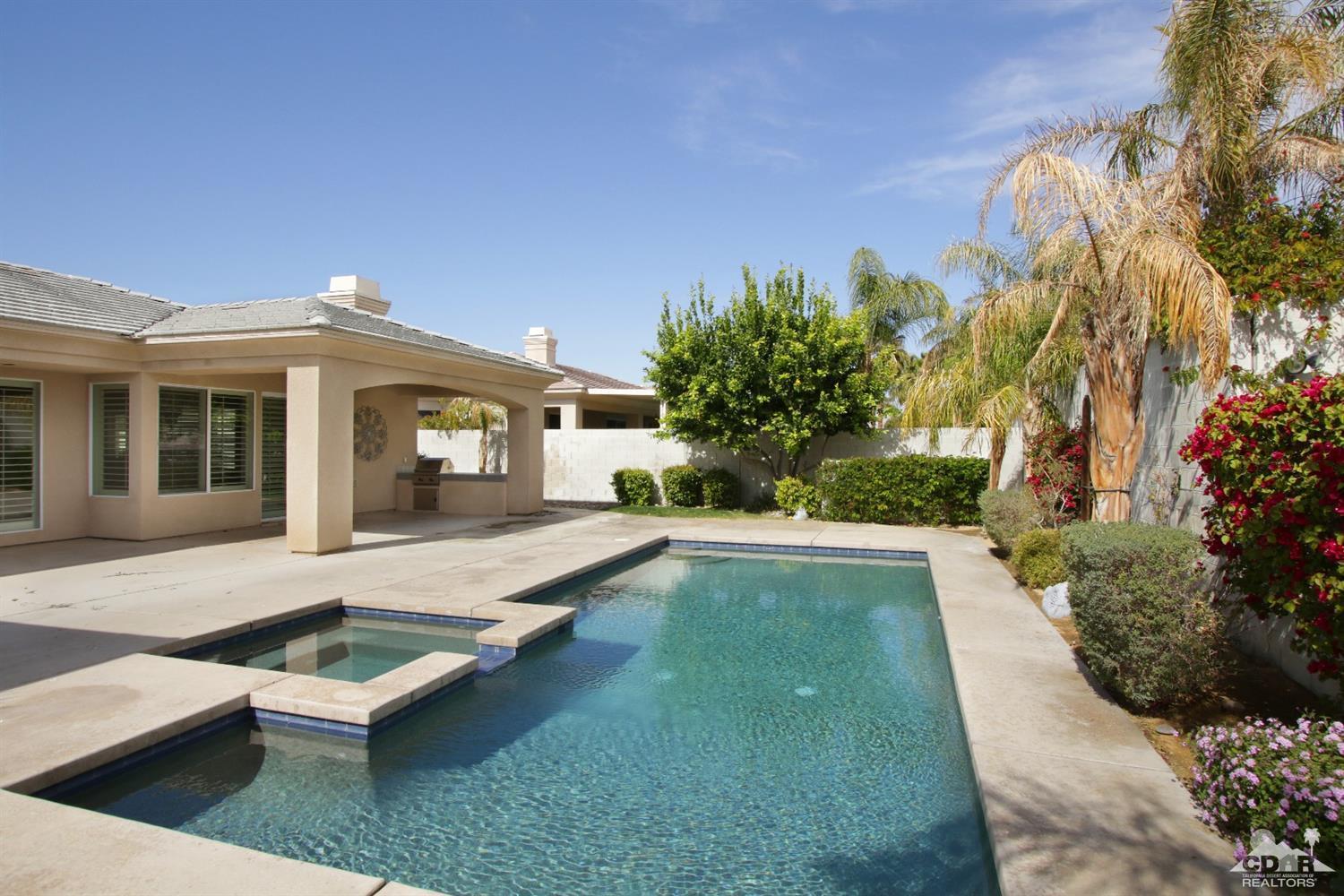 4 Orleans Road Rancho Mirage, CA 92270 - Photo 7 of 35 a swimming pool with outdoor seating yard and barbeque oven