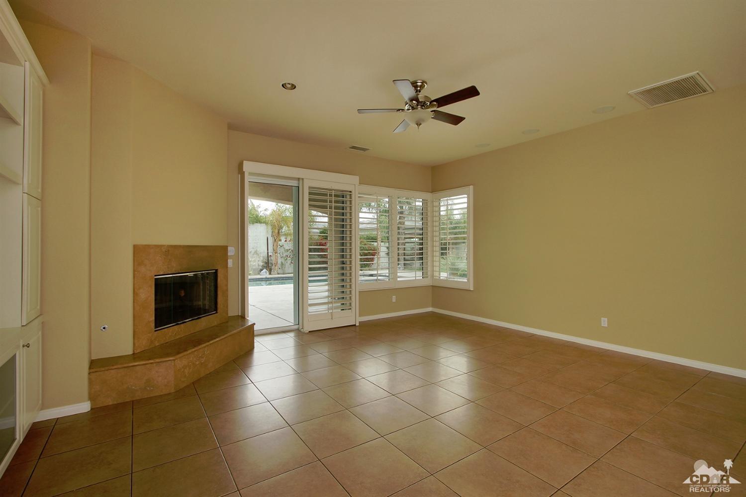 4 Orleans Road Rancho Mirage, CA 92270 - Photo 8 of 35 a view of an empty room with a fireplace and a window