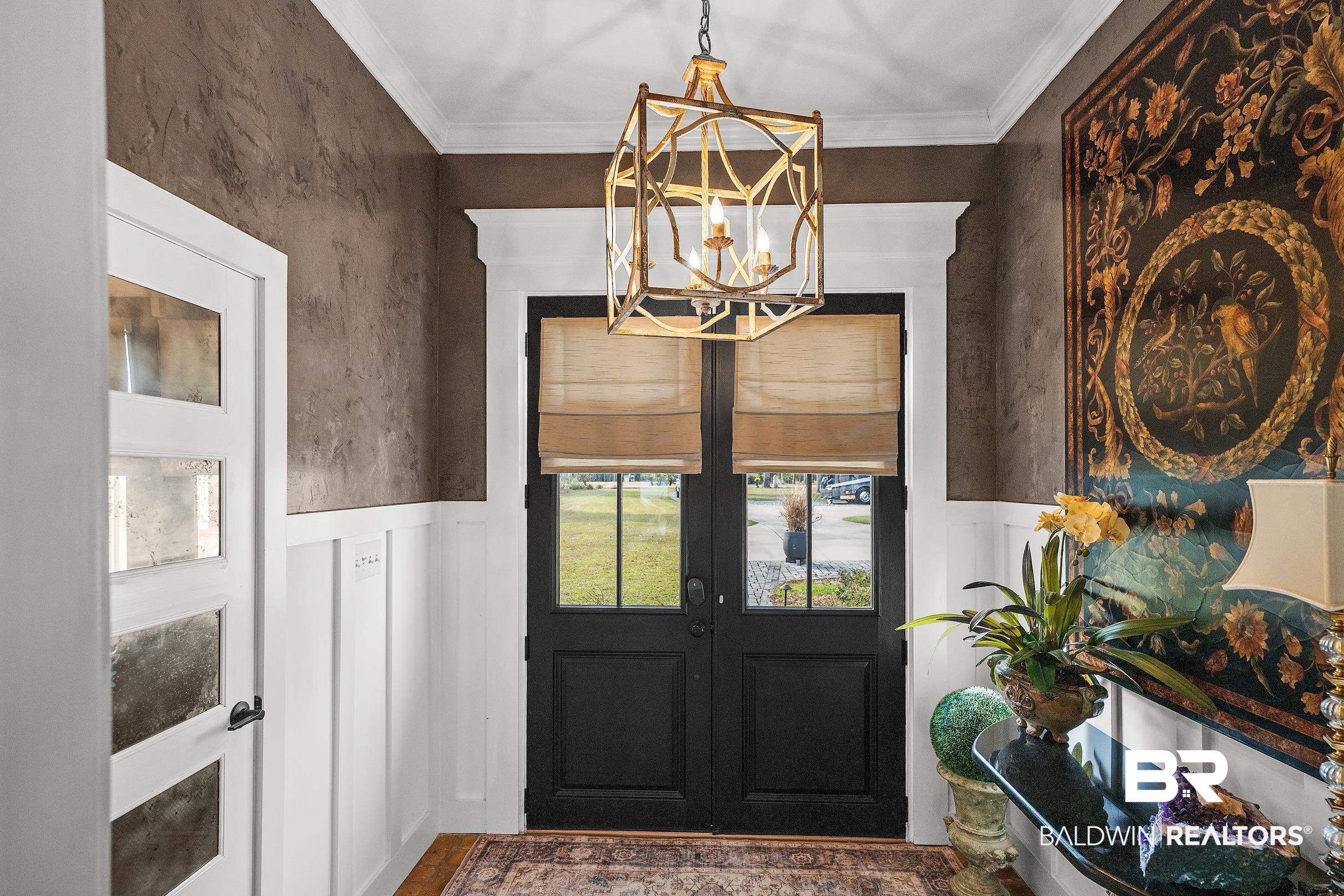 8490 Bay View Drive Foley, AL 36535 - Photo 18 of 67 Entrance foyer featuring a wainscoted wall, french doors, ornamental molding, and a chandelier