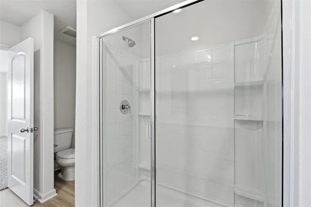 a bathroom with a shower and a toilet