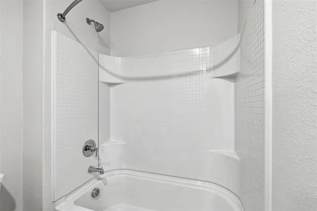 a bathroom with a tub and shower