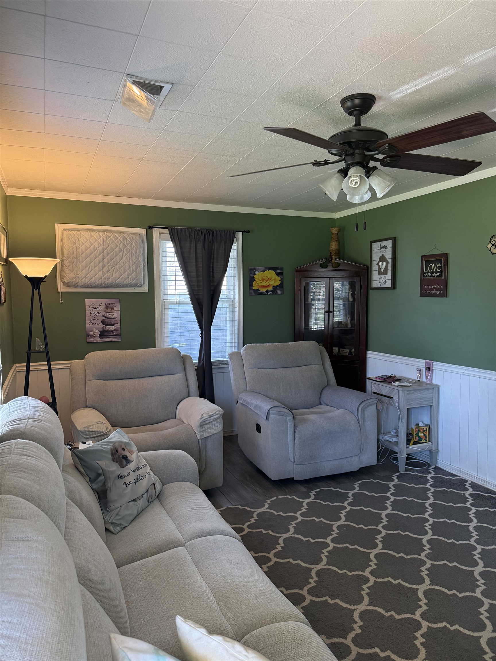 1332 Wells Station Road Memphis, TN 38108 - Photo 4 of 23 Living room featuring ceiling fan, a wainscoted wall, and ornamental molding