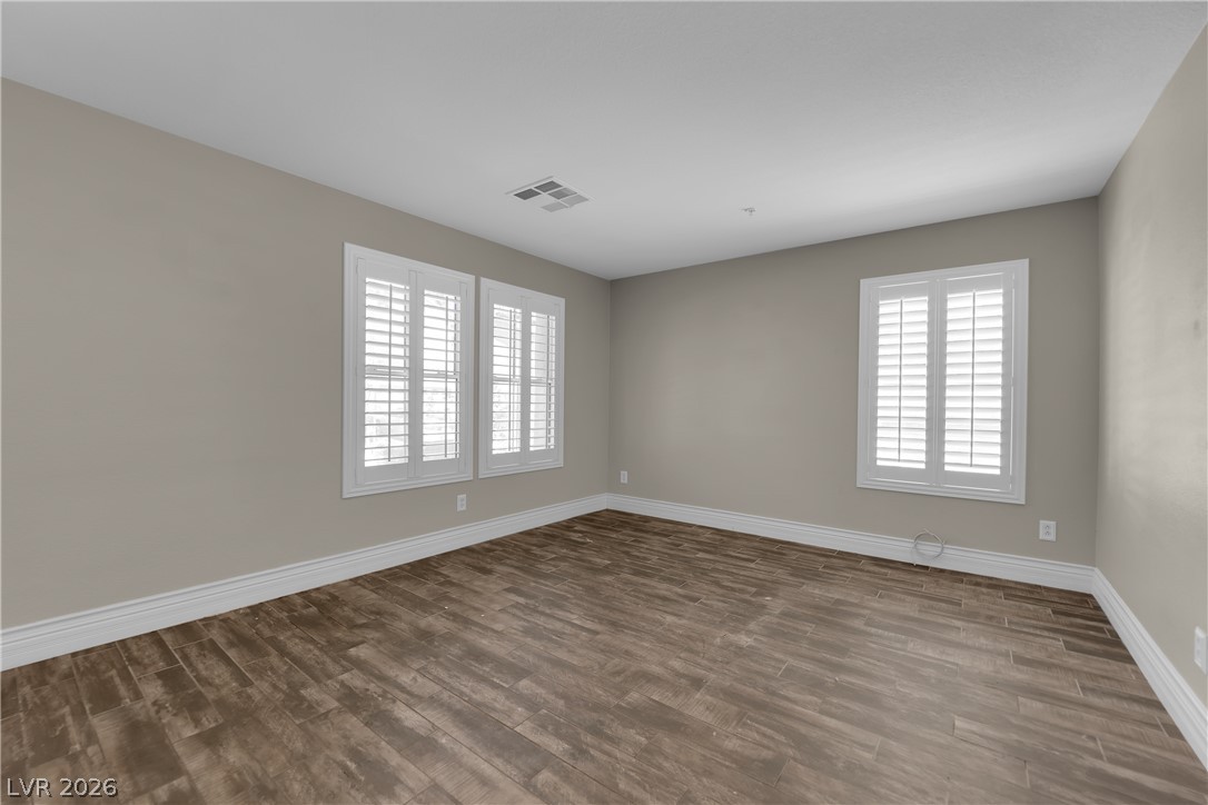646 Monument Point Street Henderson, NV 89002 - Photo 4 of 44 Natural light illuminates rich wood flooring in this inviting, versatile room.