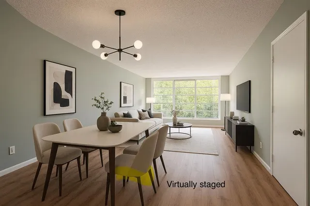 a view of a dining room with furniture window and wooden floor