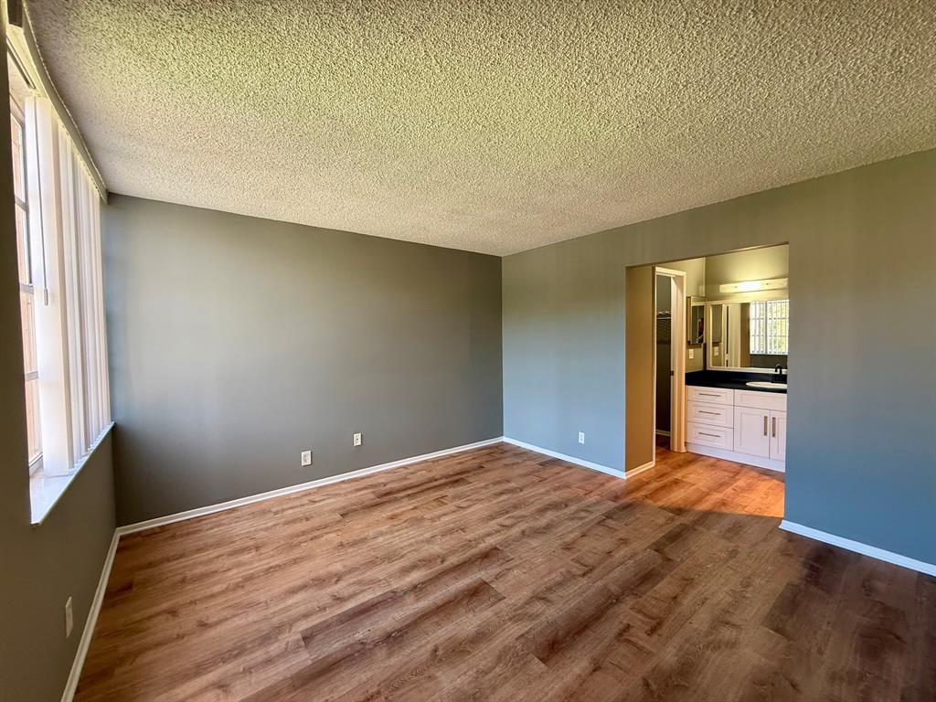 9450 Live Oak Place, Unit 303 Davie, FL 33324 - Photo 7 of 24 a view of empty room with wooden floor