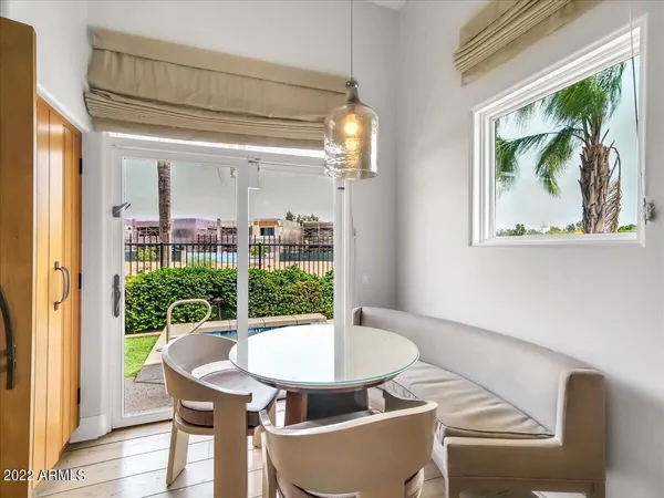 a view of a dining room with furniture wooden floor and a chandelier