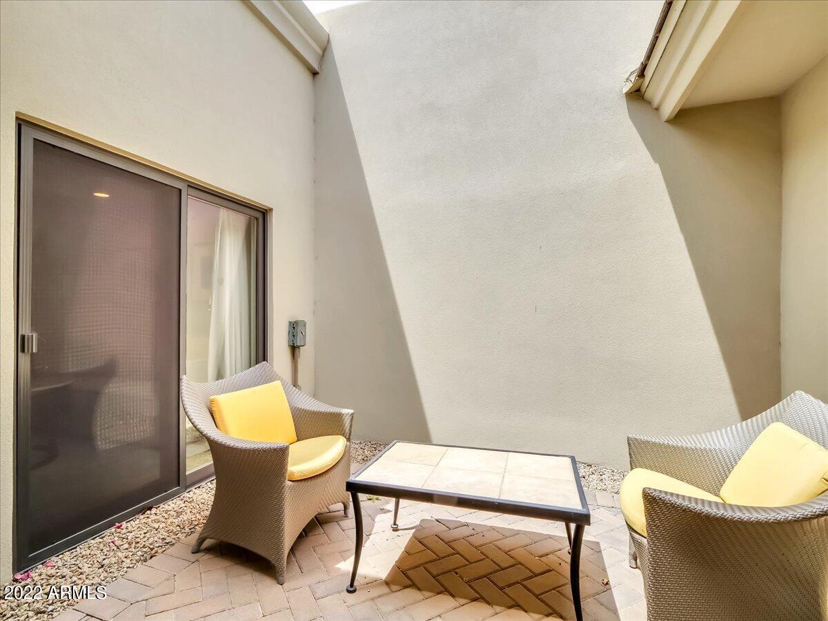 6000 East Camelback Road, Unit 7707 Scottsdale, AZ 85251 - Photo 27 of 42 a living room with chairs and a table