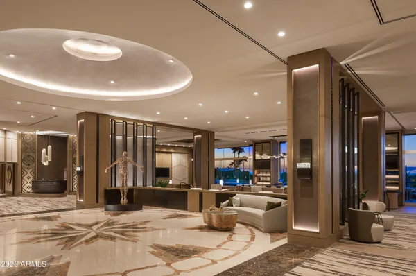 a lobby with furniture and a potted plant