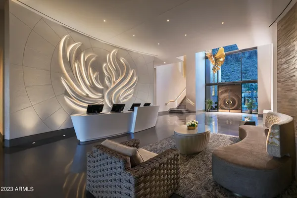 a living room with furniture and a painting on the wall