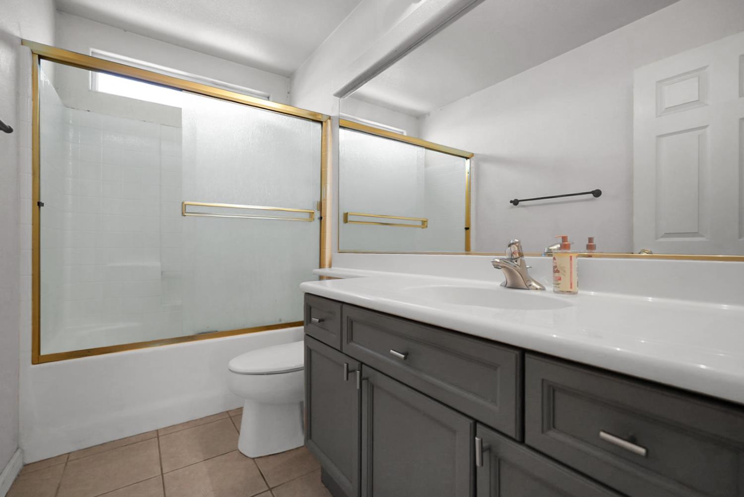 1412 Red Ribbons Lane Manteca, CA 95337 - Photo 19 of 32 a bathroom with a sink a toilet a mirror and shower