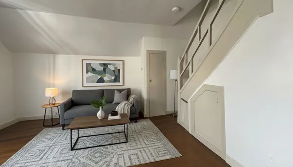 a living room with furniture and a rug