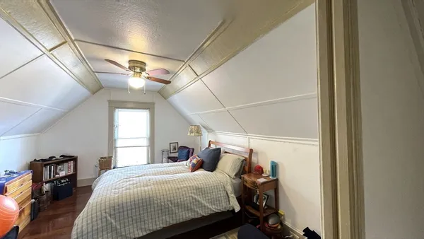 a bedroom with a bed and a mirror