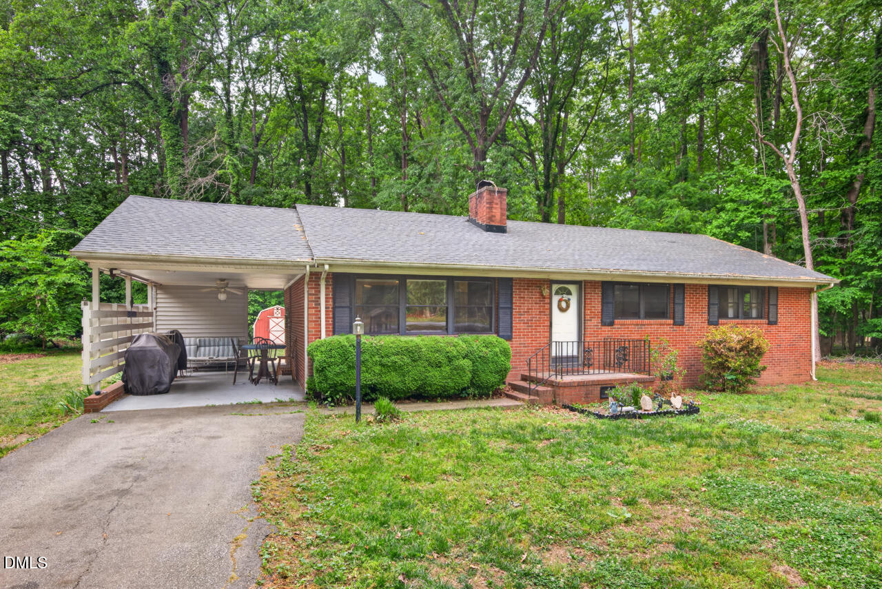 1420 Goodwin Road Durham, NC 27712 - Photo 4 of 54 a front view of a house with garden