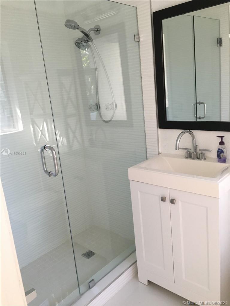 60 Park Drive, Unit D Bal Harbour, FL 33154 - Photo 13 of 13 a bathroom with a sink vanity and a mirror