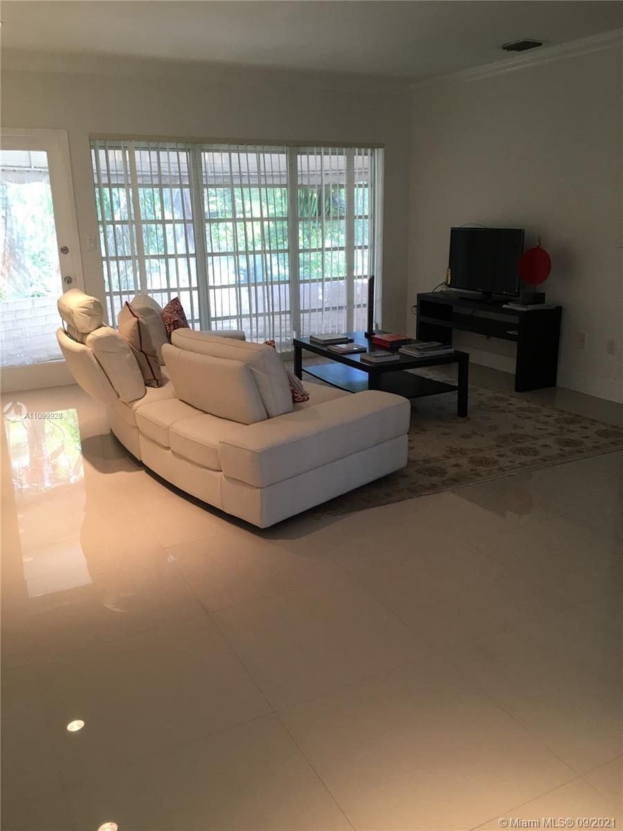 60 Park Drive, Unit D Bal Harbour, FL 33154 - Photo 3 of 13 a living room with furniture and a flat screen tv