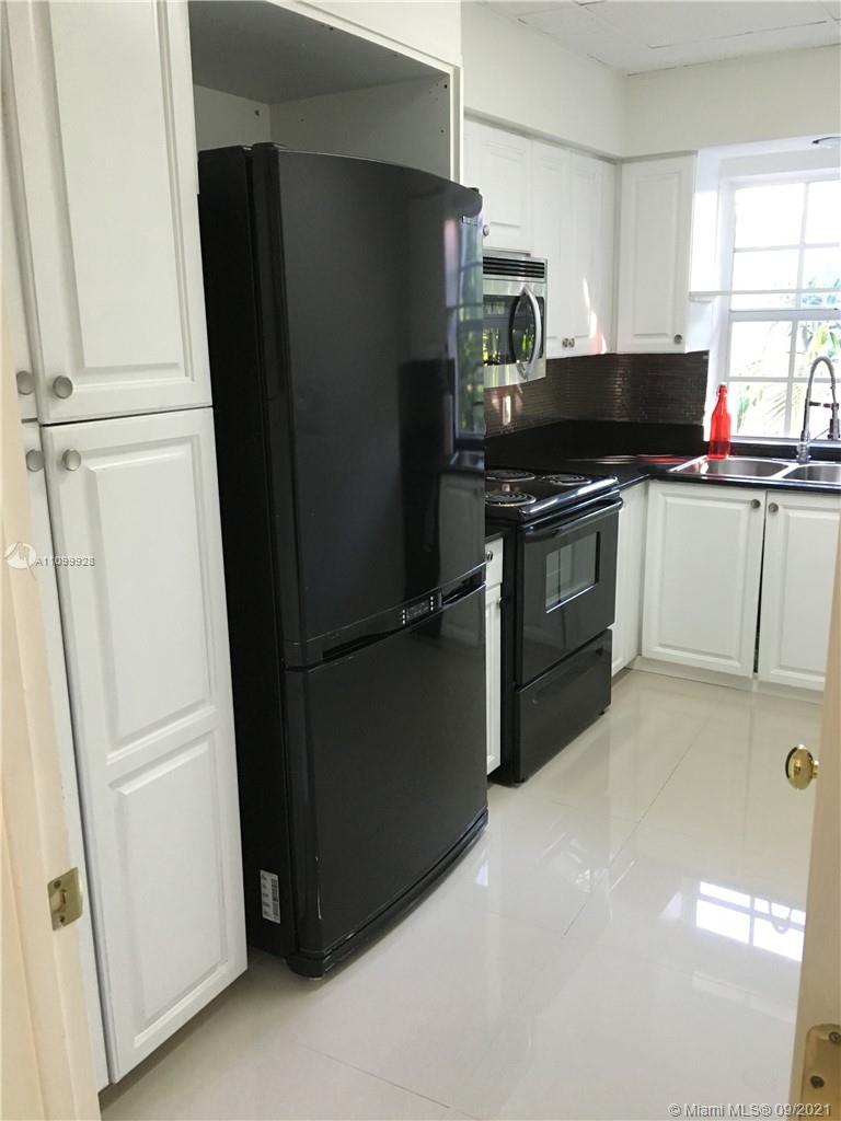 60 Park Drive, Unit D Bal Harbour, FL 33154 - Photo 6 of 13 a kitchen with a refrigerator and a stove