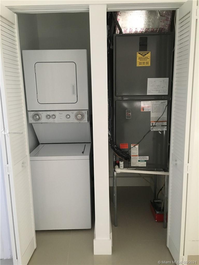 60 Park Drive, Unit D Bal Harbour, FL 33154 - Photo 8 of 13 a room with a washer and dryer