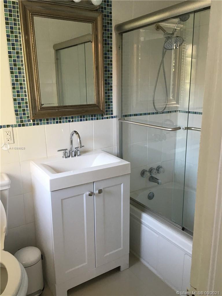 60 Park Drive, Unit D Bal Harbour, FL 33154 - Photo 10 of 13 a bathroom with a sink a toilet and shower