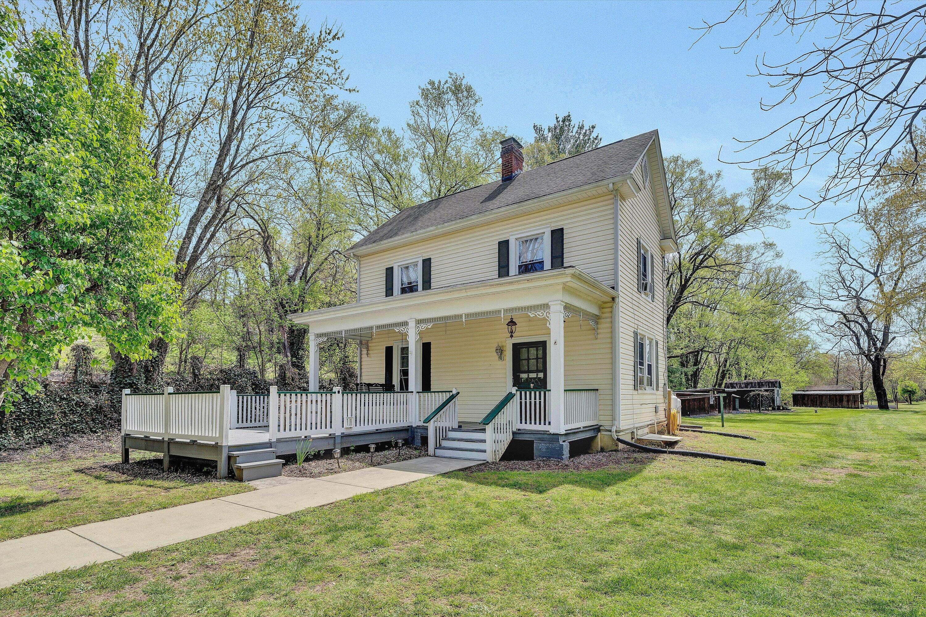 a view of a house with backyard porch and sitting area