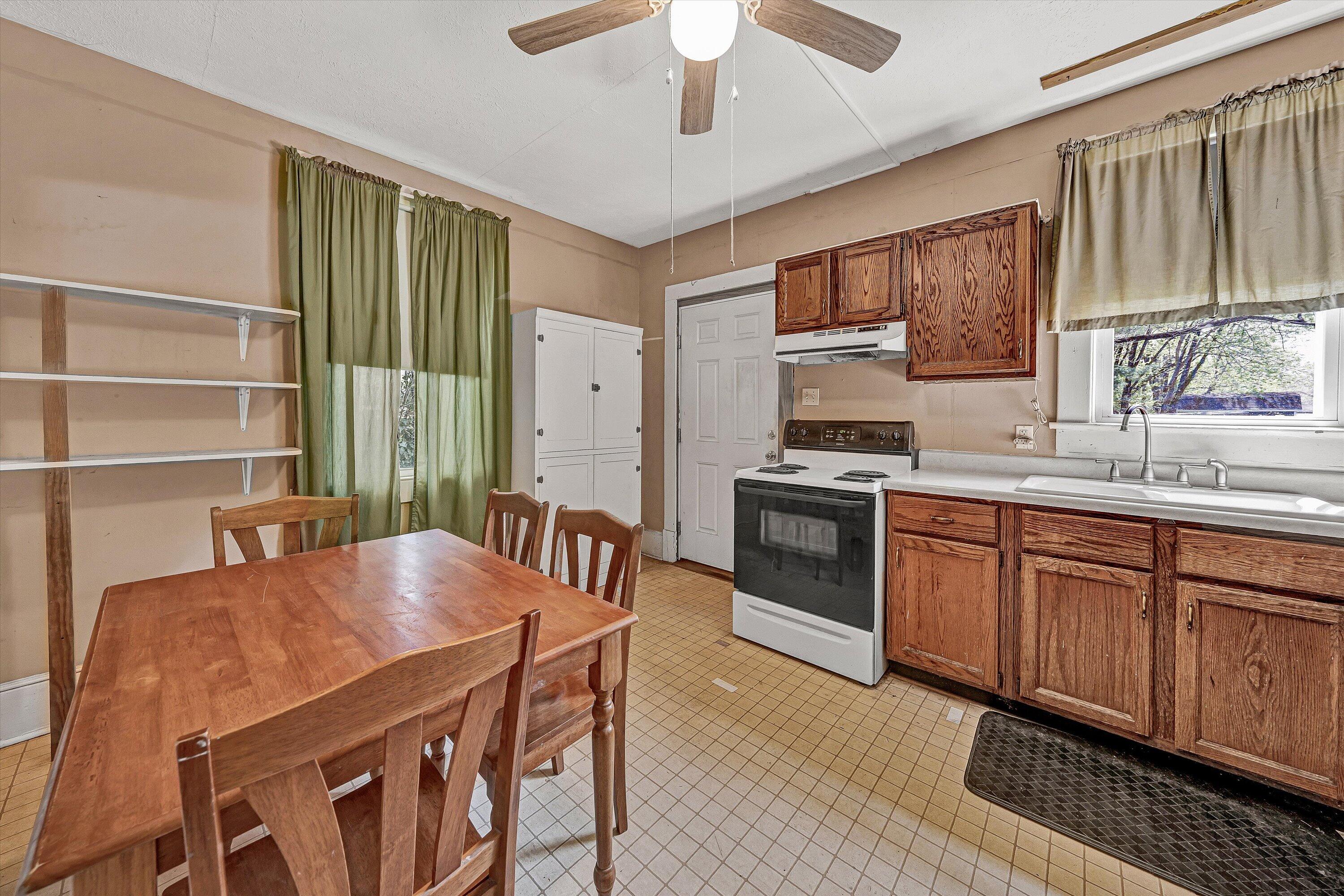 4787 Glade Creek Road Roanoke, VA 24012 - Photo 11 of 37 a kitchen with stainless steel appliances granite countertop a stove a sink dishwasher and cabinets