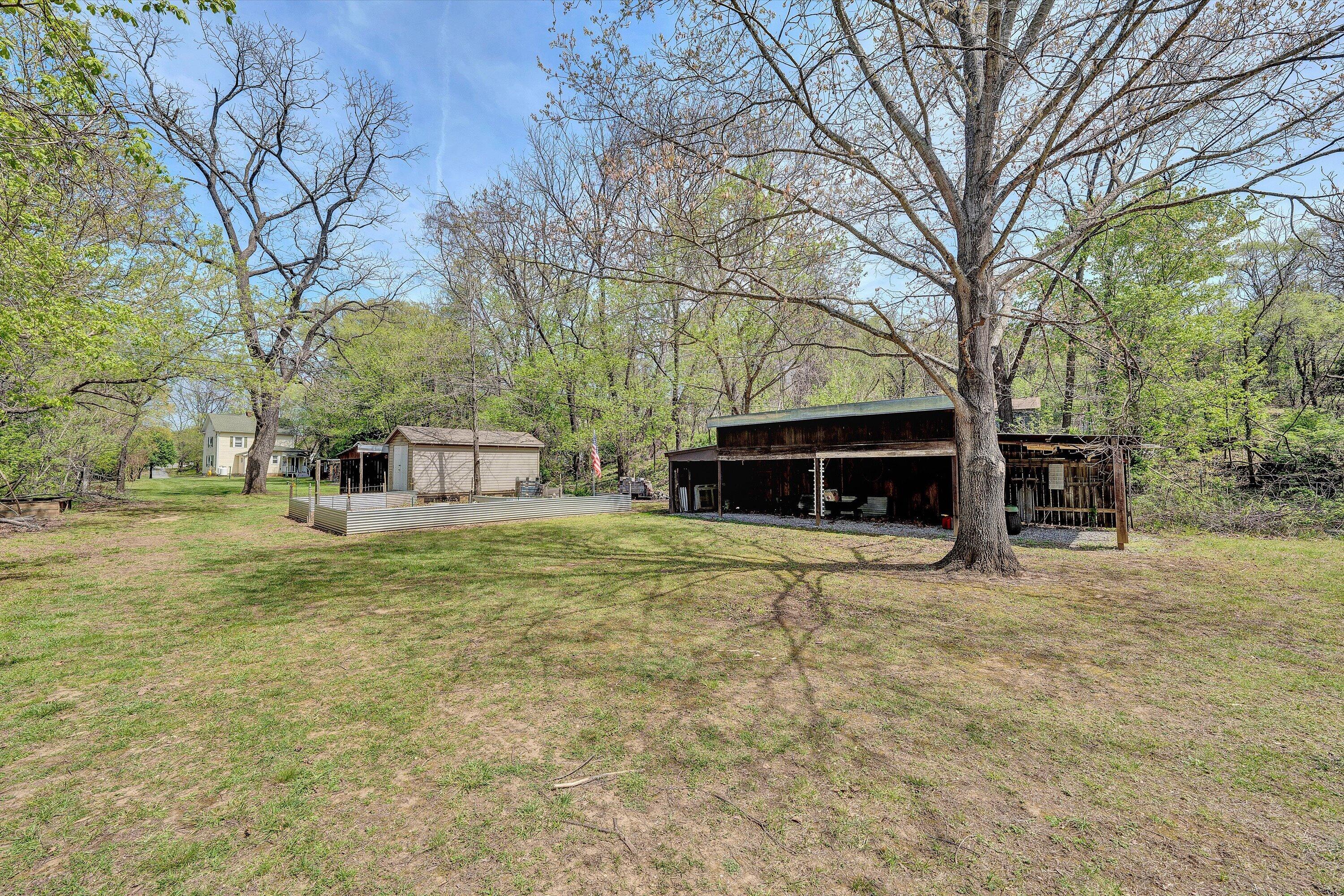 4787 Glade Creek Road Roanoke, VA 24012 - Photo 24 of 37 a front view of a house with a yard and garage
