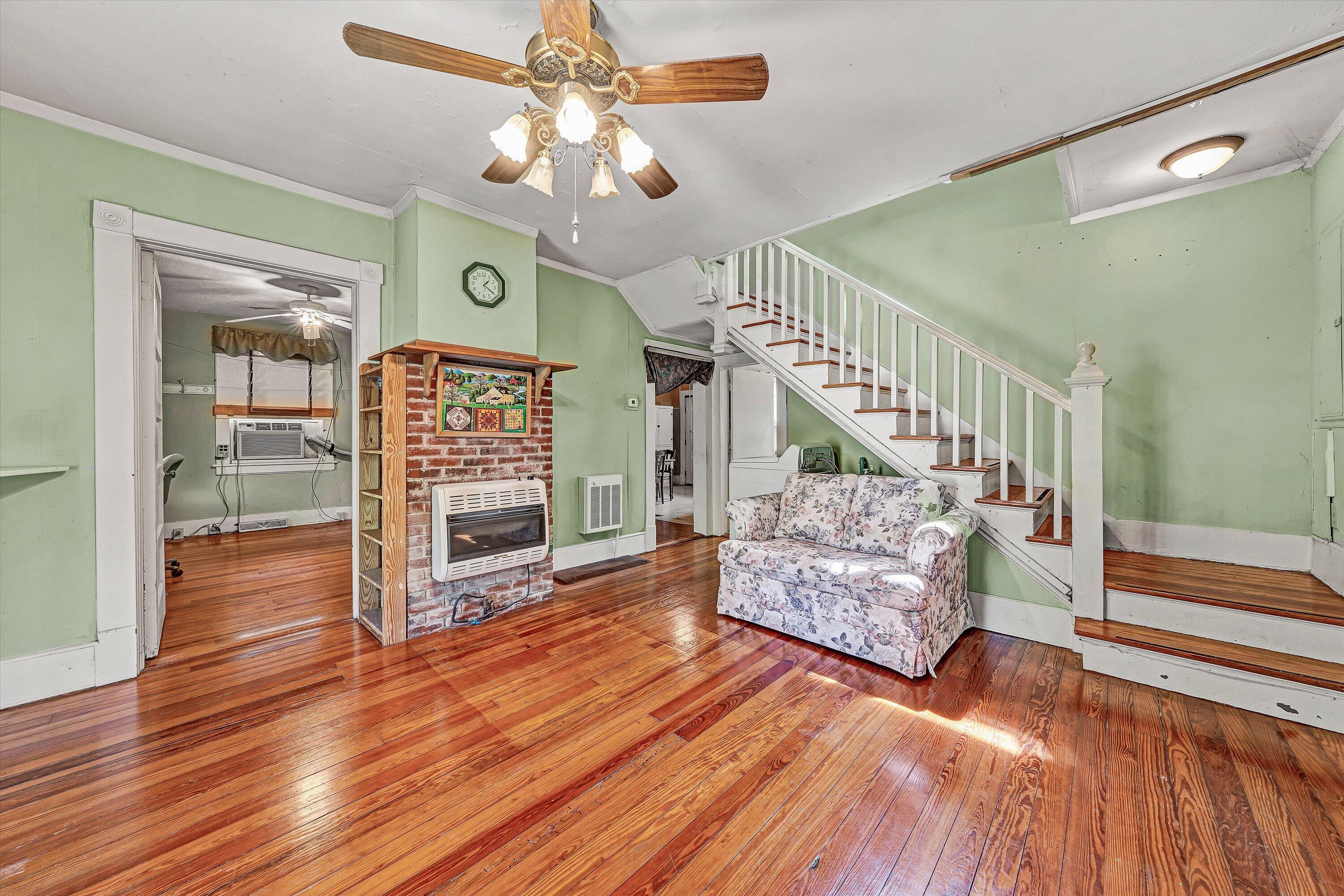 4787 Glade Creek Road Roanoke, VA 24012 - Photo 6 of 37 a view of an entryway with wooden floor door a mirror and a chandelier fan
