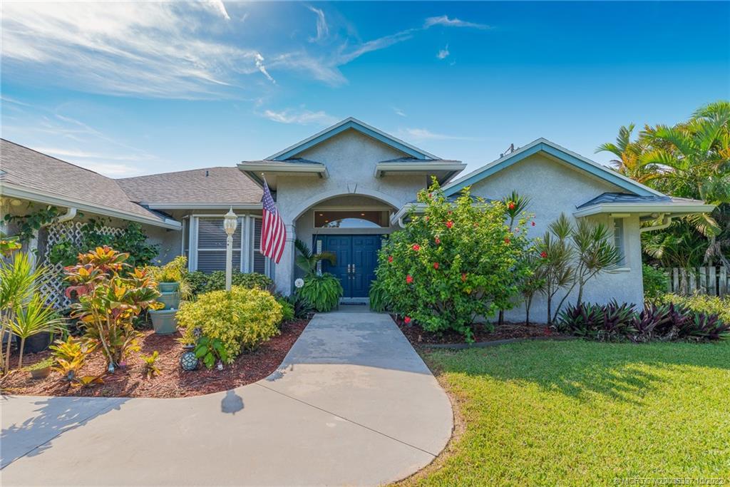 5374 Southeast Horseshoe Point Road Stuart, FL 34997 - Photo 1 of 38 a front view of a house with garden