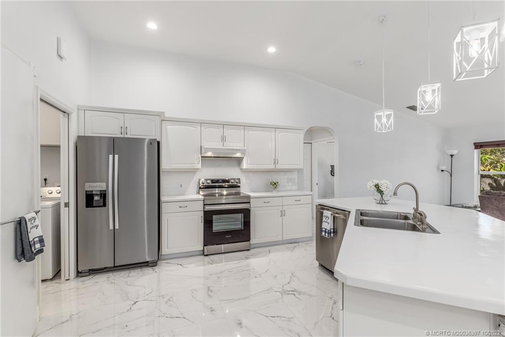 5374 Southeast Horseshoe Point Road Stuart, FL 34997 - Photo 18 of 38 a kitchen with stainless steel appliances a refrigerator sink and stove