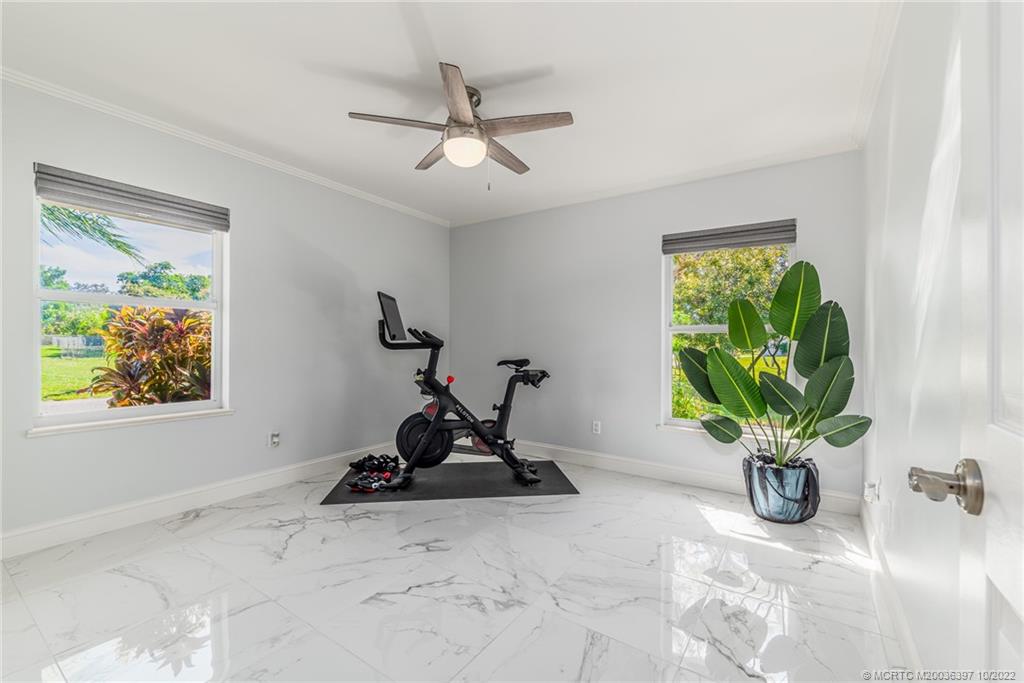 5374 Southeast Horseshoe Point Road Stuart, FL 34997 - Photo 23 of 38 a view of a workspace with furniture and a potted plant