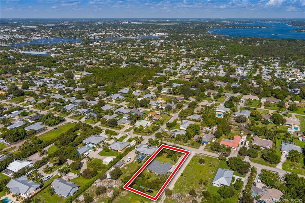 5374 Southeast Horseshoe Point Road Stuart, FL 34997 - Photo 33 of 38 an aerial view of residential houses with outdoor space and trees