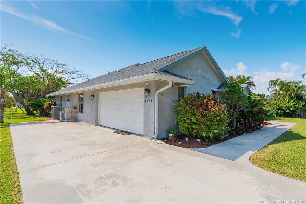 5374 Southeast Horseshoe Point Road Stuart, FL 34997 - Photo 4 of 38 a front view of a house with garden