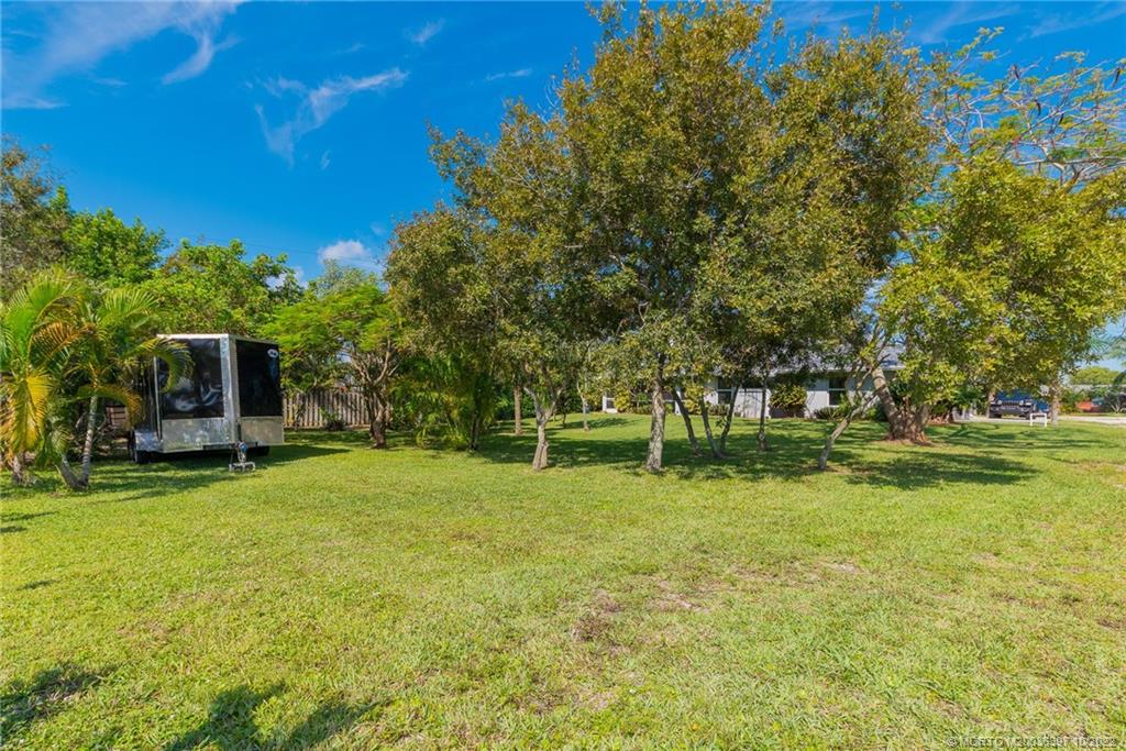 5374 Southeast Horseshoe Point Road Stuart, FL 34997 - Photo 9 of 38 a backyard of a house with table and chairs