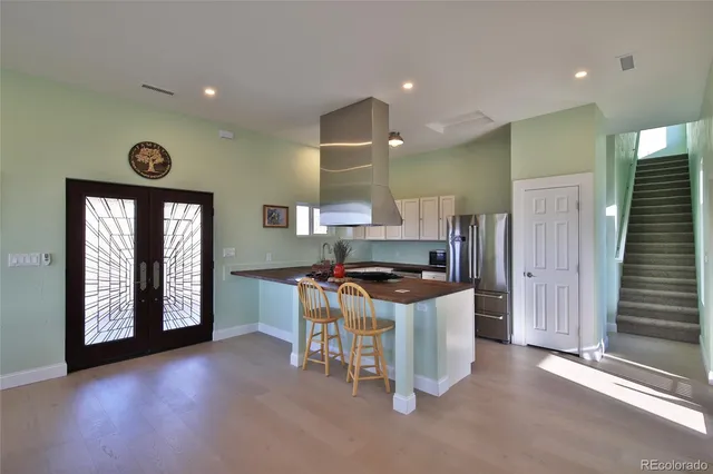 a kitchen with a stove a refrigerator and a sink