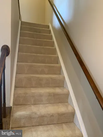 a view of staircase with white walls