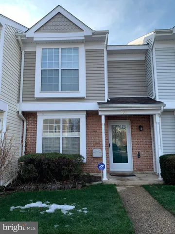 a front view of a house with a garden and yard