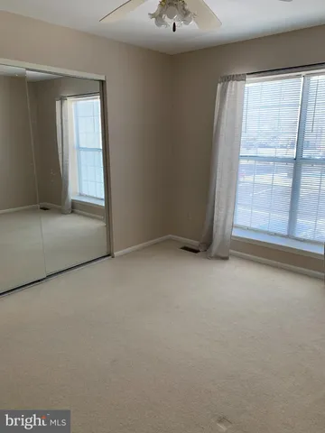an empty room with a empty space and windows