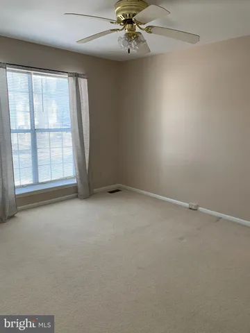 an empty room with a empty space and windows