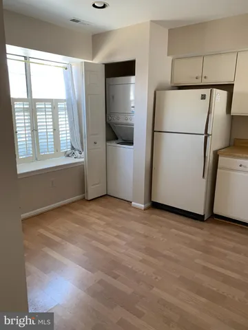 a view of a kitchen with a refrigerator and microwave