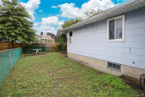 a backyard of a house with a garden and plants