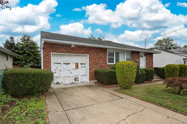 a view of a car parked in front of a brick house