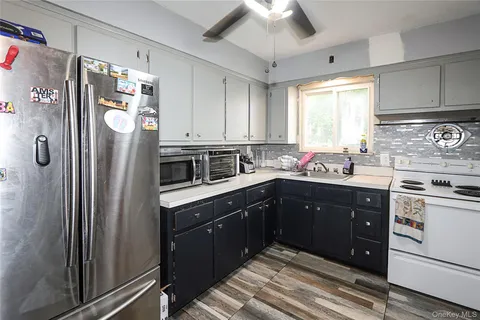 a kitchen with stainless steel appliances a refrigerator sink and cabinets