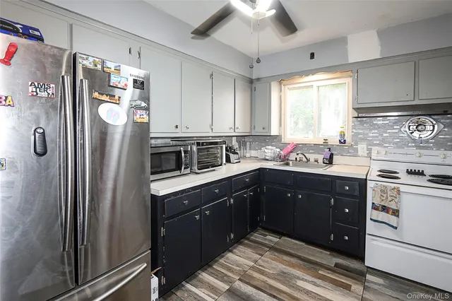 a kitchen with stainless steel appliances a refrigerator sink and cabinets