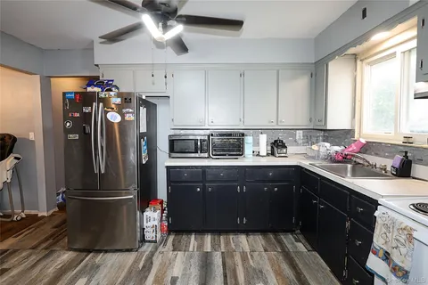 a kitchen with a refrigerator sink and cabinets