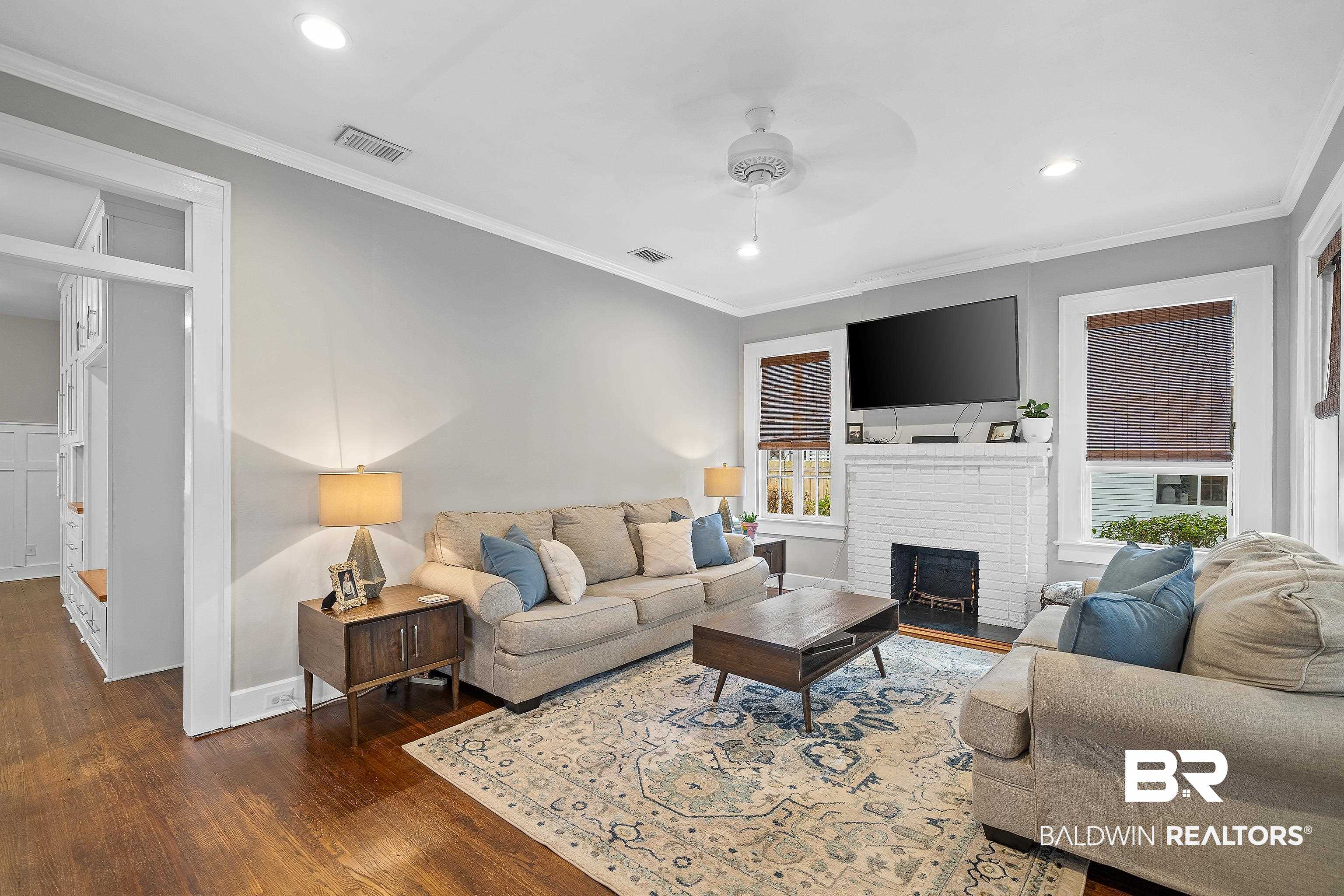 111 Macy Place Mobile, AL 36604 - Photo 5 of 35 The Living Room features great traditional details in the fireplace and crown moulding yet feels light and updated.
