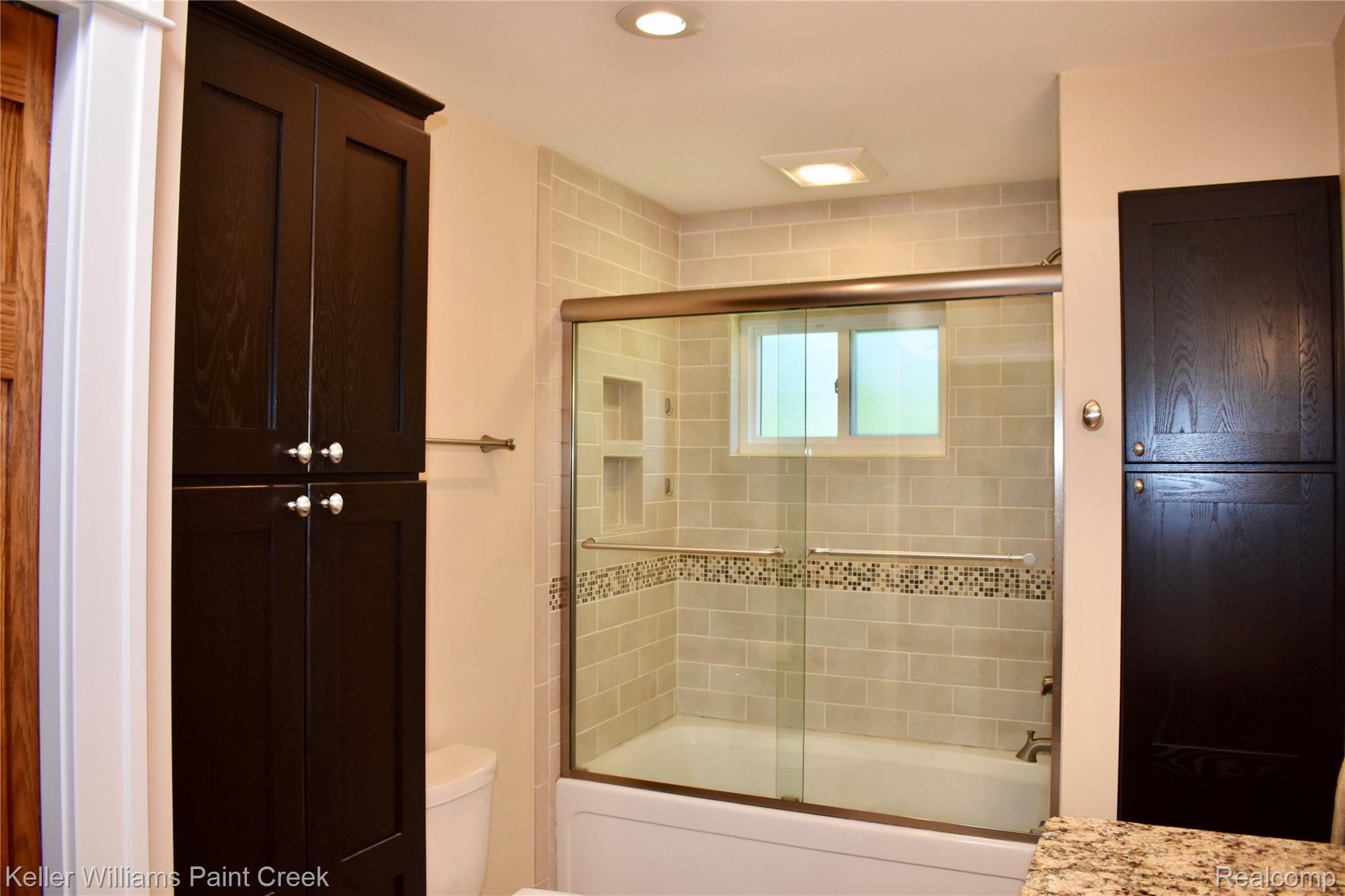 132 Brewster Road Rochester, MI 48309 - Photo 18 of 32 CHECKOUT ALL OF THE CABINET SPACE & "CUSTOM" TILE IN THE BATH IN THE LARGE (7 X 13) 1ST FLOOR BATHROOM