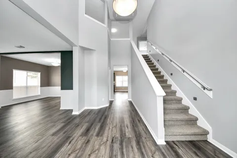 a view of an entryway with wooden floor