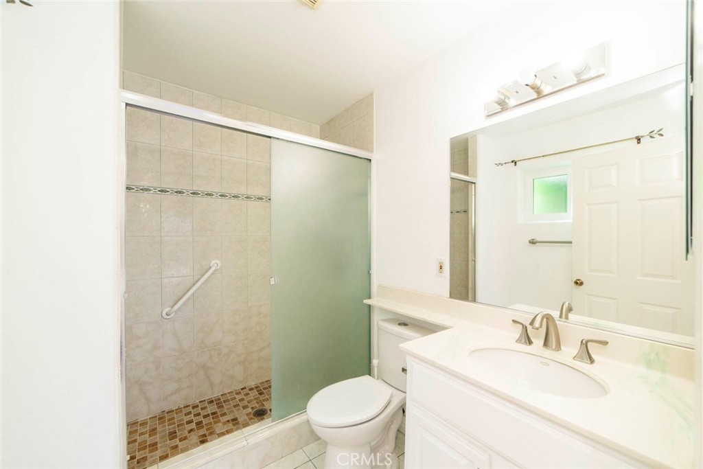 1 Camden Irvine, CA 92620 - Photo 17 of 43 a bathroom with a granite countertop sink toilet and shower